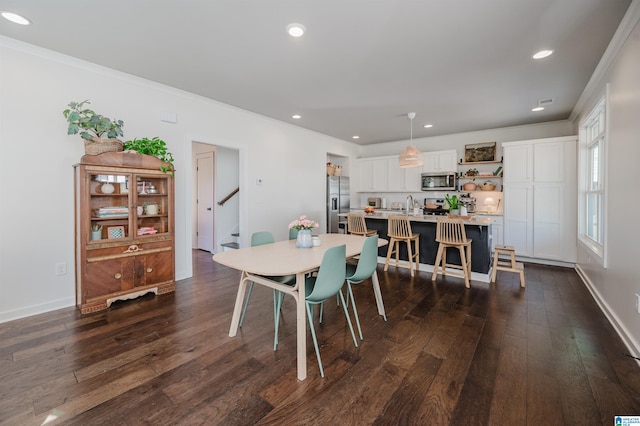 dining room with ornamental molding, dark wood finished floors, recessed lighting, baseboards, and stairs