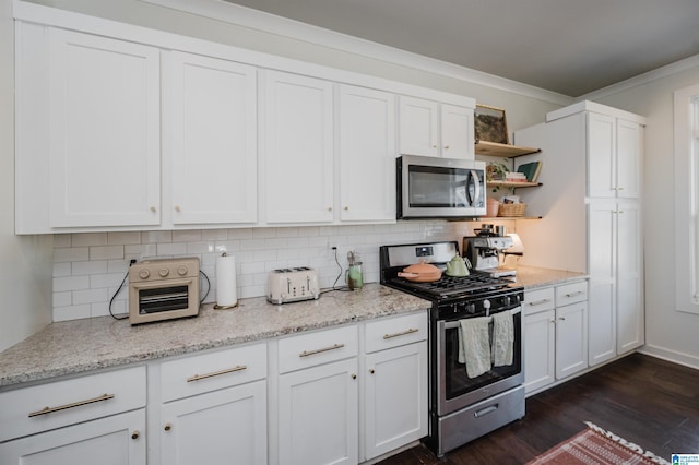 kitchen with appliances with stainless steel finishes, white cabinetry, dark wood-type flooring, and open shelves