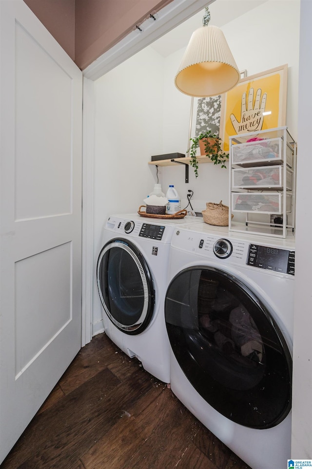 laundry area with separate washer and dryer, dark wood-style flooring, and laundry area