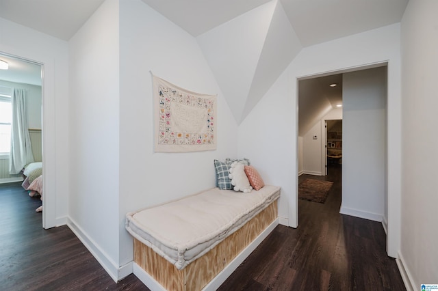 corridor with baseboards and wood finished floors