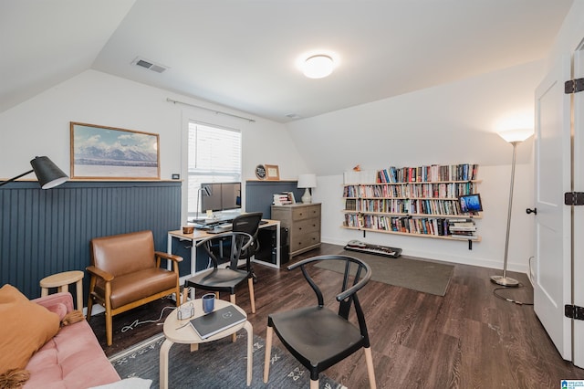 home office featuring visible vents, wood finished floors, and vaulted ceiling