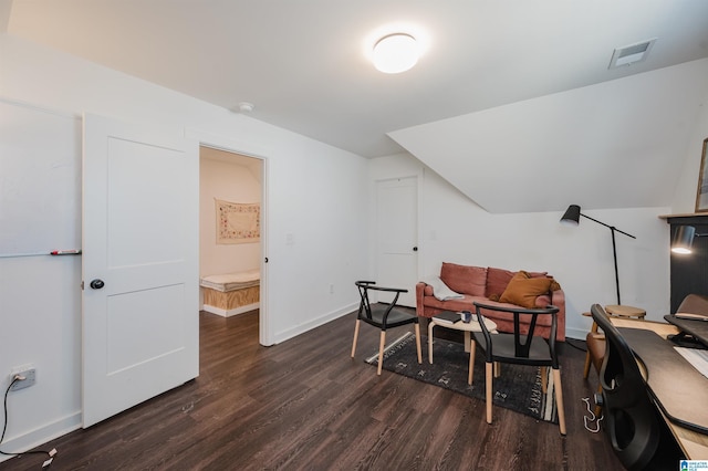 interior space featuring visible vents, baseboards, dark wood-style floors, and vaulted ceiling