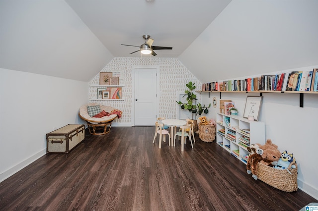 rec room with baseboards, lofted ceiling, wood finished floors, and a ceiling fan