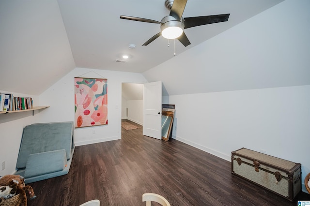 additional living space featuring a ceiling fan, wood finished floors, visible vents, baseboards, and vaulted ceiling