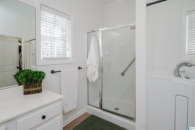 full bath with vanity, a shower stall, and ornamental molding