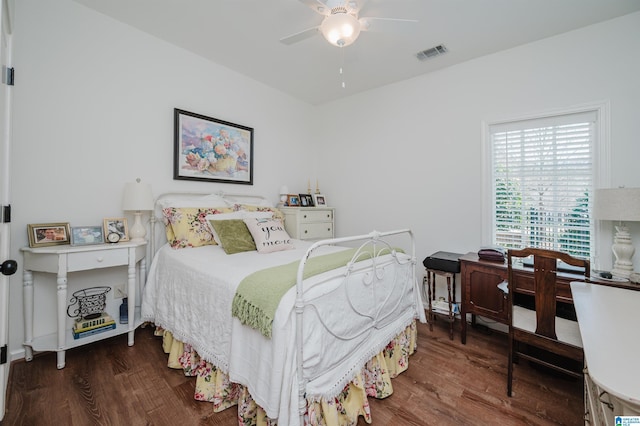 bedroom featuring visible vents, a ceiling fan, and wood finished floors