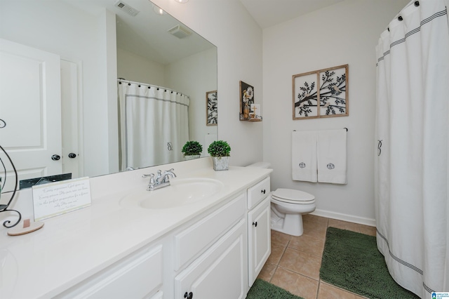 full bathroom featuring vanity, baseboards, visible vents, tile patterned floors, and toilet