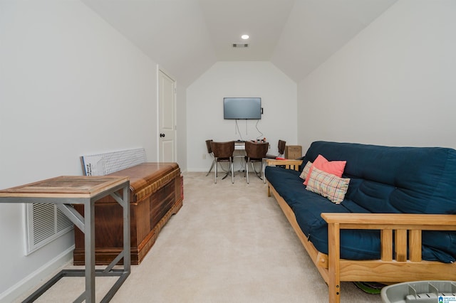 living area with baseboards, lofted ceiling, light colored carpet, and visible vents