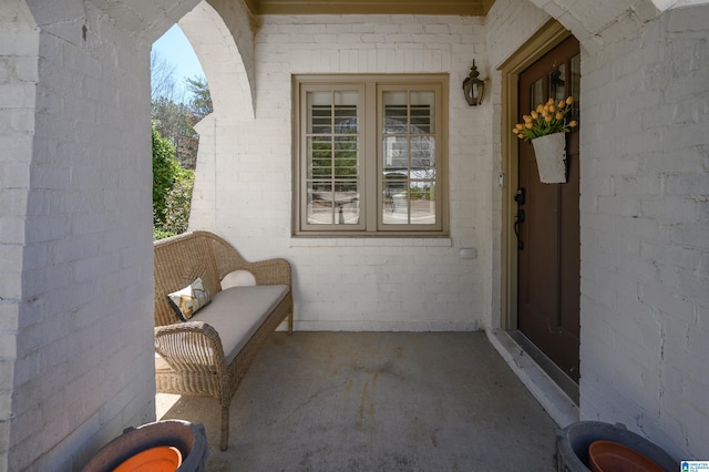 view of exterior entry featuring brick siding