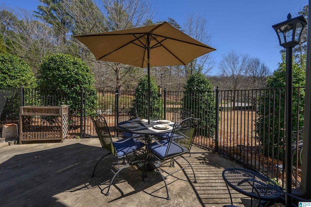 view of patio / terrace with outdoor dining space and fence