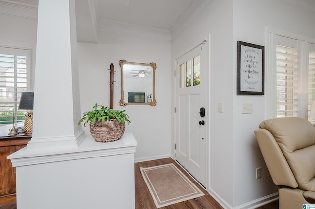 entryway with baseboards, wood finished floors, and crown molding