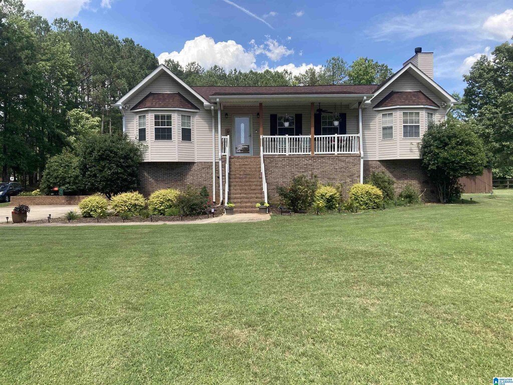 11973 Cotton Cir, Mccalla, AL 35111 - ranch-style home with brick siding, covered porch, a chimney, and a front lawn