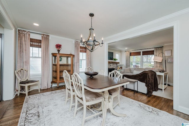 dining room featuring crown molding, baseboards, a chandelier, recessed lighting, and dark wood-style flooring