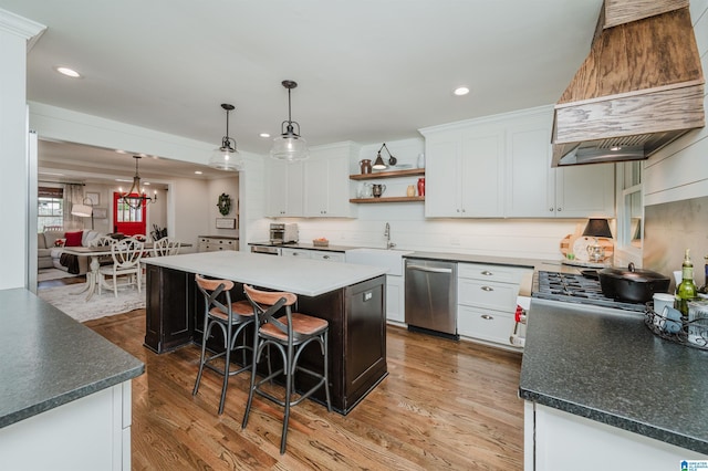 kitchen featuring a kitchen island, custom exhaust hood, open shelves, a sink, and stainless steel dishwasher