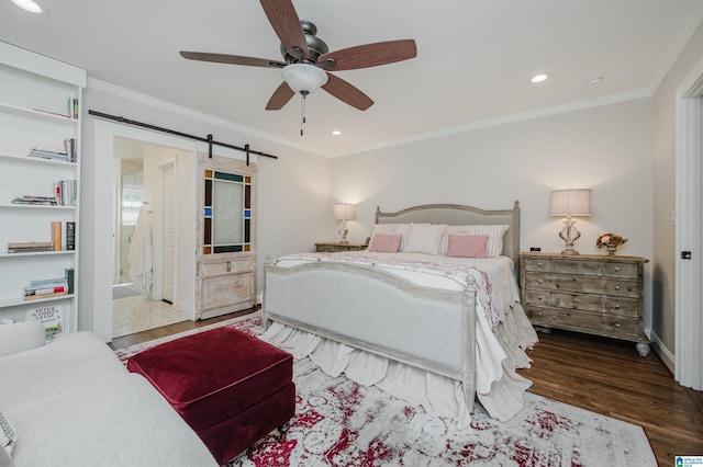 bedroom with wood finished floors, recessed lighting, ceiling fan, ornamental molding, and a barn door