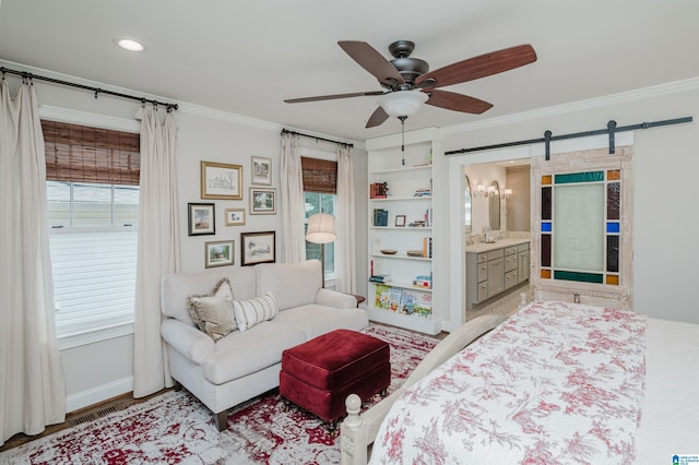 bedroom featuring crown molding, a barn door, baseboards, and ceiling fan