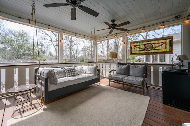 sunroom with wood ceiling and a ceiling fan