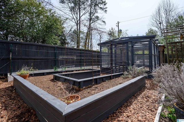 view of yard with an outdoor structure, a garden, and fence