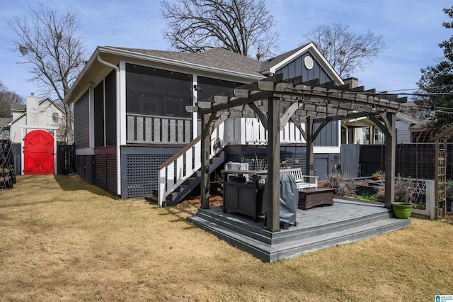 wooden deck featuring fence, a pergola, a sunroom, an outdoor structure, and a lawn