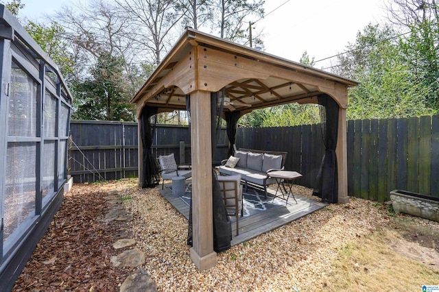 view of patio featuring a gazebo, an outdoor hangout area, and a fenced backyard