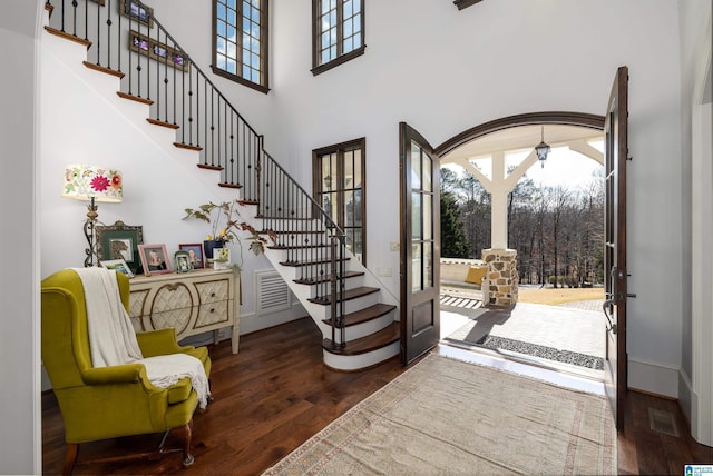 entryway featuring stairs, wood finished floors, and visible vents