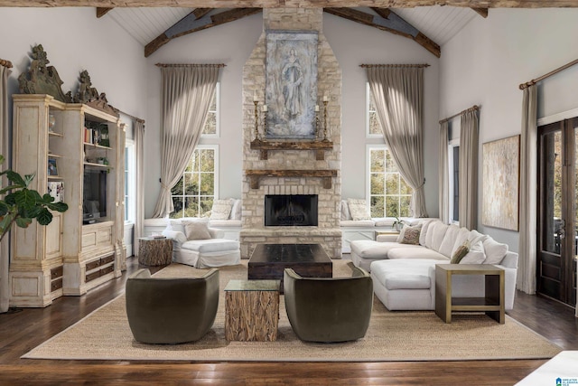 living area with dark wood finished floors, beamed ceiling, wood ceiling, and a fireplace