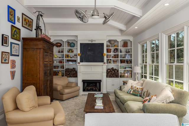 living area with recessed lighting, beamed ceiling, and a fireplace