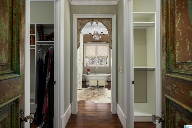 hall featuring an inviting chandelier and dark wood-style floors