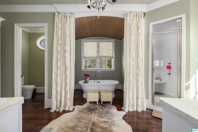 full bathroom featuring a soaking tub, wood finished floors, and a tile shower