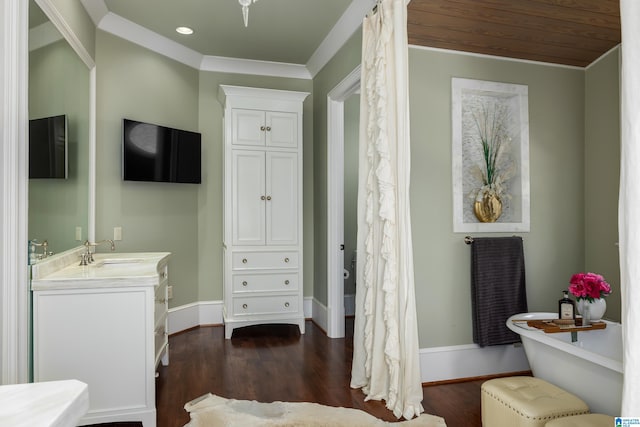 full bath featuring baseboards, a freestanding bath, recessed lighting, wood finished floors, and vanity