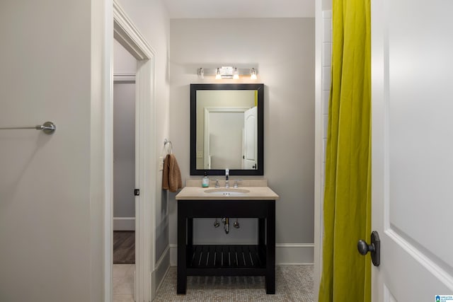 bathroom featuring tile patterned floors, vanity, and baseboards