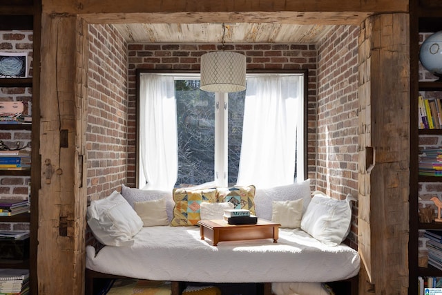 living room with beamed ceiling, brick wall, and wooden ceiling