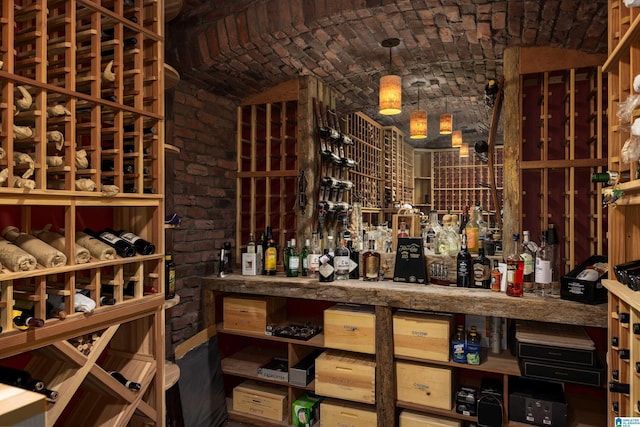 wine cellar featuring brick ceiling and brick wall