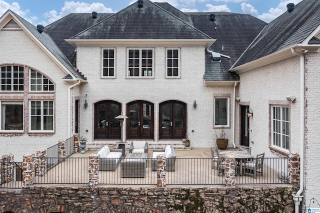 back of house with a patio area, french doors, fence private yard, and brick siding