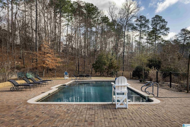 view of swimming pool with a patio area, fence, and a fenced in pool