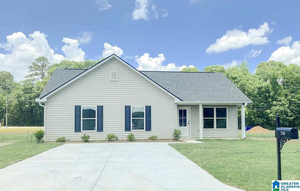 single story home with a front lawn and roof with shingles