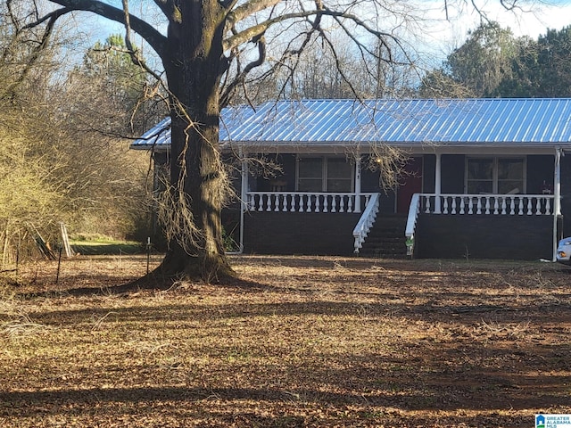 view of front of home with a porch and metal roof