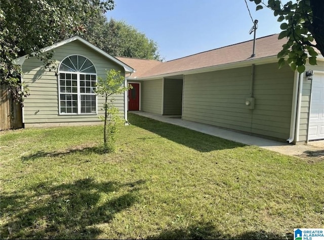 exterior space with a lawn and an attached garage