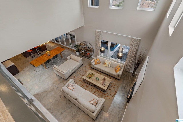 living area with stairway and a high ceiling