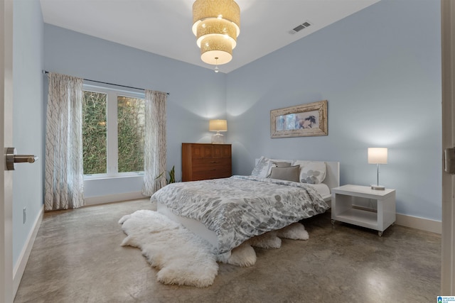 bedroom with baseboards, visible vents, and concrete floors