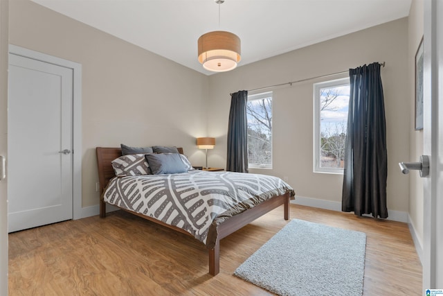 bedroom featuring light wood-type flooring and baseboards