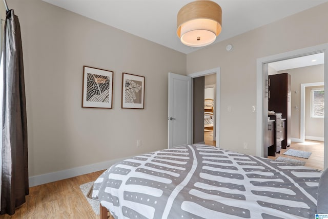 bedroom with wood finished floors and baseboards