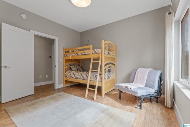 bedroom with baseboards and wood finished floors