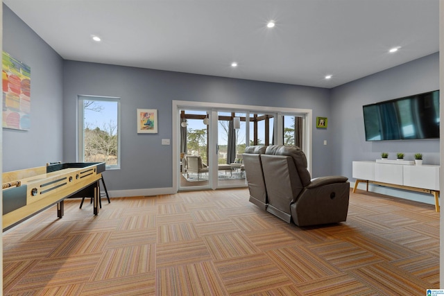 living area with recessed lighting, baseboards, and light colored carpet