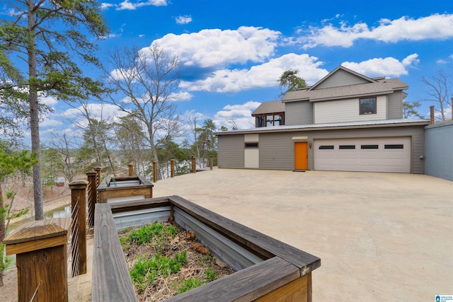 exterior space with concrete driveway and an attached garage