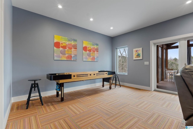 recreation room with recessed lighting, light colored carpet, and baseboards