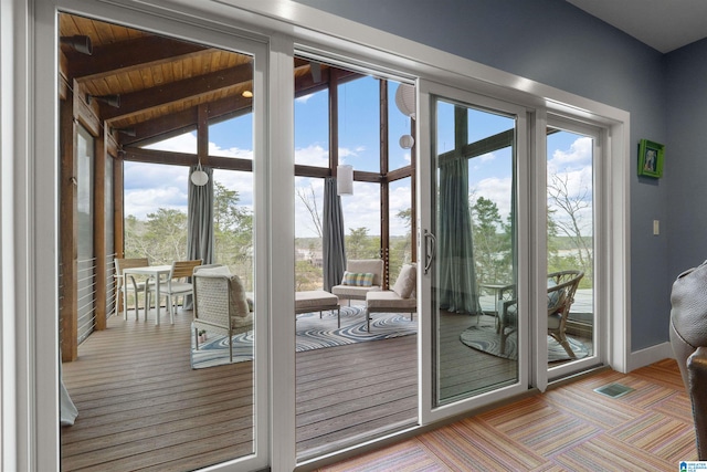 entryway with wooden ceiling, beamed ceiling, and baseboards