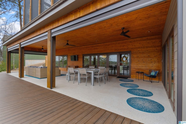 deck featuring outdoor dining area, an outdoor hangout area, and a ceiling fan