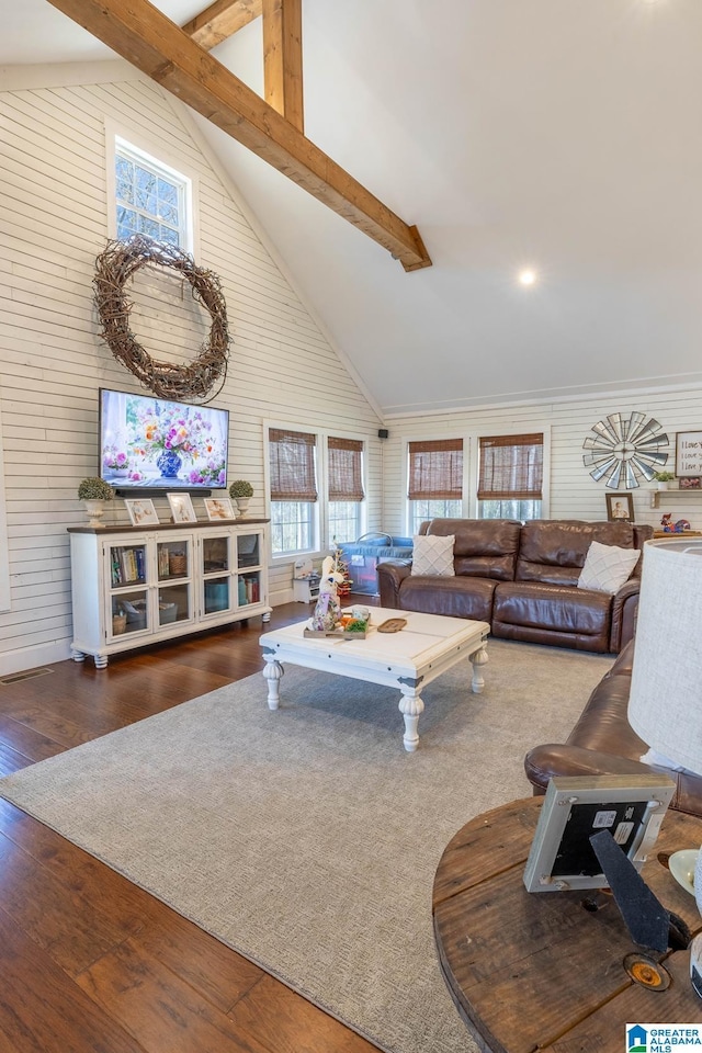 living room featuring beam ceiling, high vaulted ceiling, and wood-type flooring