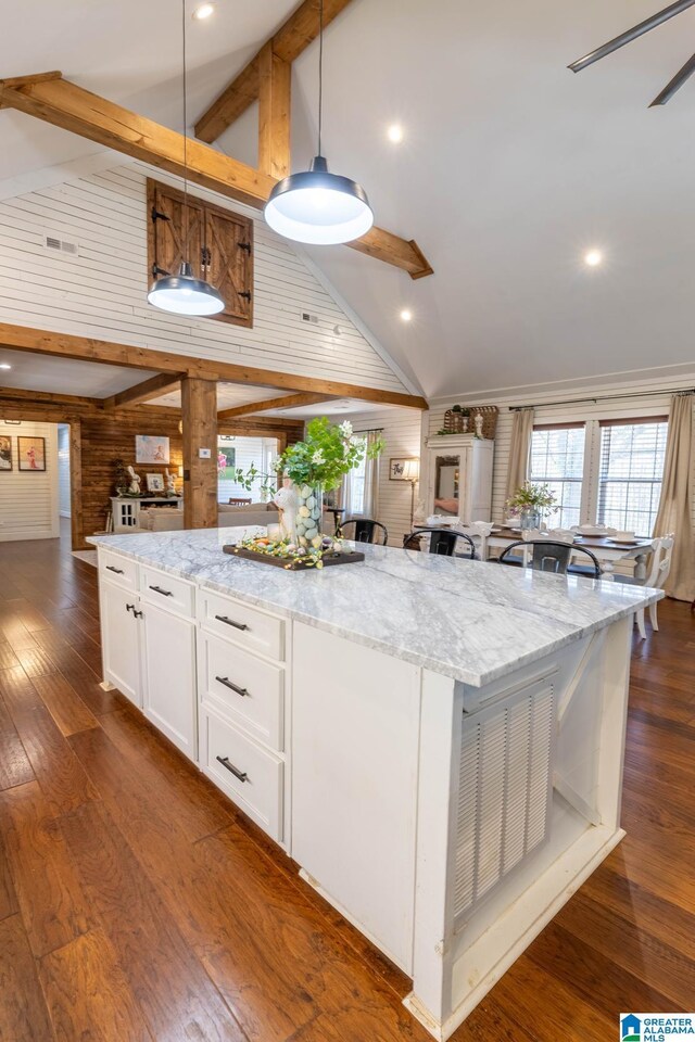 kitchen featuring dark wood-style floors, beamed ceiling, white cabinetry, and a large island